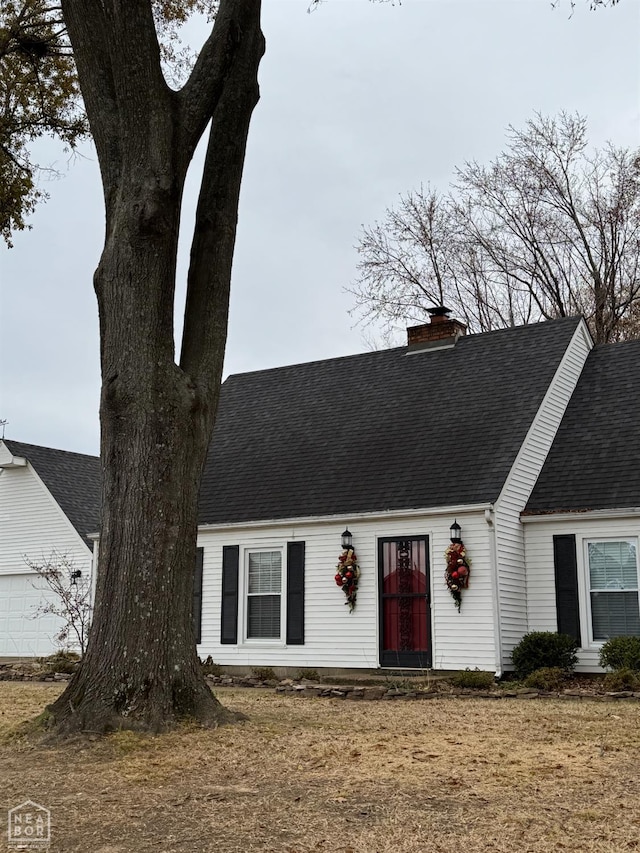 2704 Greenbriar Dr, Jonesboro, AR 72401 - cape cod-style house featuring a shingled roof, a chimney, and a garage