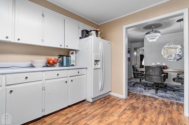 2300 Mount Carmel Rd, Paragould, AR 72450 - kitchen with white fridge with ice dispenser, crown molding, light wood-type flooring, white cabinetry, and light countertops