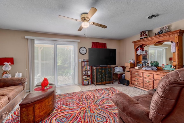 2300 Mount Carmel Rd, Paragould, AR 72450 - carpeted living area featuring ceiling fan and a textured ceiling