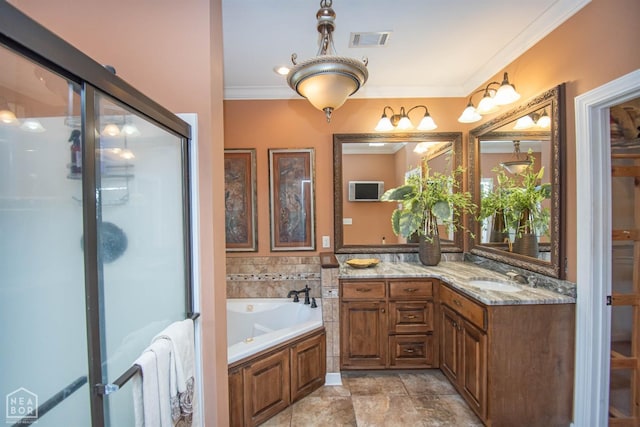 bathroom featuring a garden tub, vanity, a stall shower, and visible vents