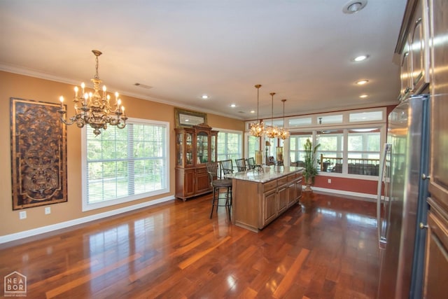 kitchen featuring baseboards, stainless steel fridge, a chandelier, and crown molding