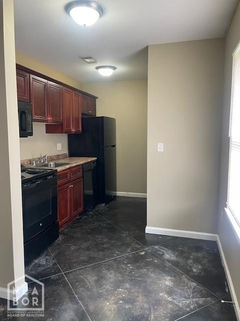 2206 Willow Rd, Jonesboro, AR 72401 - kitchen featuring black appliances, baseboards, dark brown cabinets, and a sink