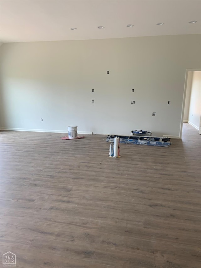 unfurnished living room with baseboards, recessed lighting, and wood finished floors