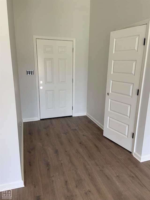 interior space with baseboards and dark wood finished floors