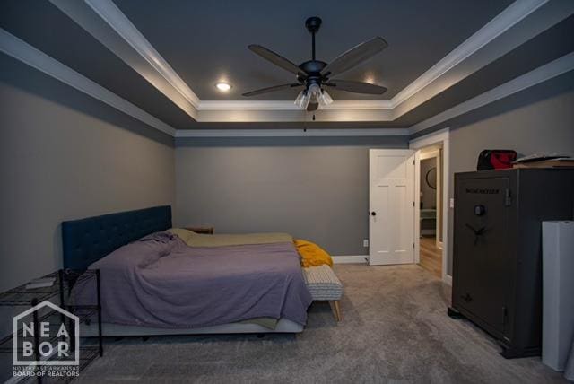carpeted bedroom with a raised ceiling, baseboards, and ornamental molding
