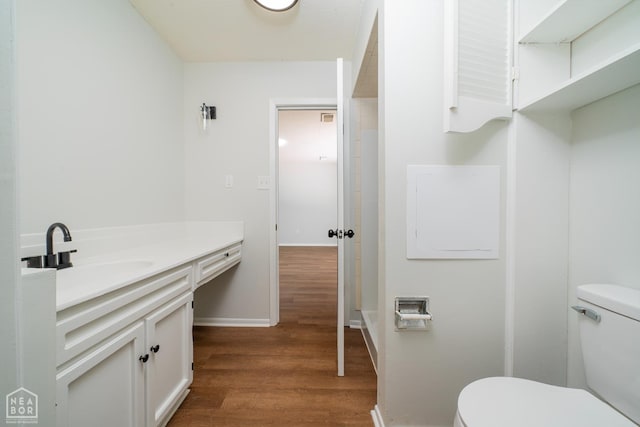 2109 Munos Ln, Jonesboro, AR 72401 - bathroom featuring toilet, wood finished floors, vanity, and baseboards