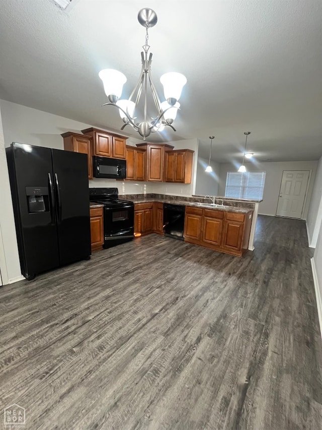 3721 Remington Dr, Jonesboro, AR 72404 - kitchen featuring black appliances, a chandelier, dark wood-style flooring, a peninsula, and brown cabinets