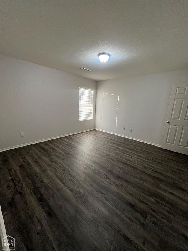 3721 Remington Dr, Jonesboro, AR 72404 - empty room featuring dark wood-style flooring and baseboards