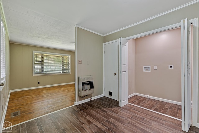 34 Adams St, Wilson, AR 72395 - spare room featuring heating unit, wood finished floors, ornamental molding, and baseboards