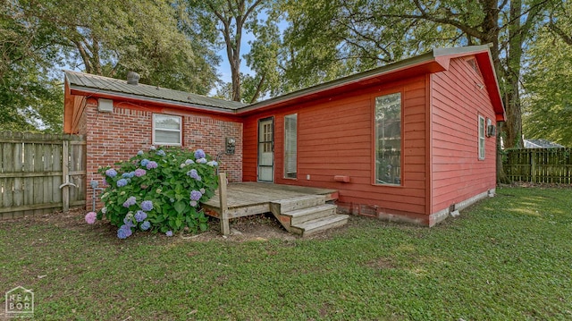 34 Adams St, Wilson, AR 72395 - back of property featuring metal roof, a deck, and crawl space