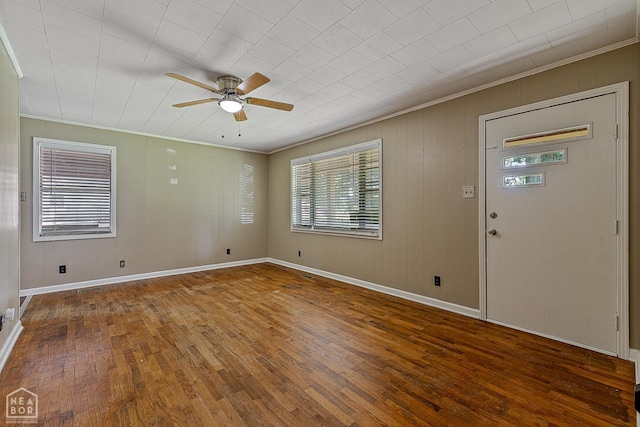 34 Adams St, Wilson, AR 72395 - empty room featuring ornamental molding, a ceiling fan, wood-type flooring, and baseboards