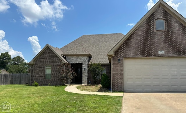 828 Laura Lea, Jonesboro, AR 72401 - view of front of home with brick siding, a shingled roof, driveway, and a garage