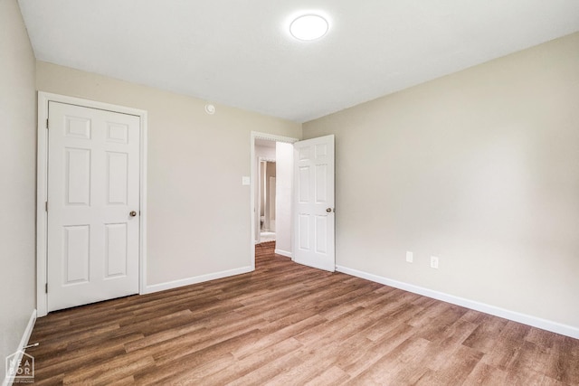 1615 Duncan Rd, Jonesboro, AR 72401 - unfurnished bedroom featuring wood finished floors and baseboards