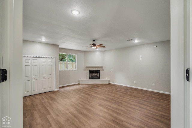 1615 Duncan Rd, Jonesboro, AR 72401 - unfurnished living room with a ceiling fan, wood finished floors, a fireplace with raised hearth, and recessed lighting