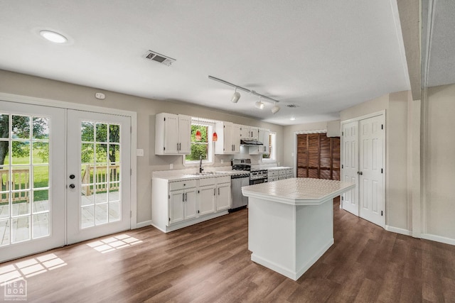 1615 Duncan Rd, Jonesboro, AR 72401 - kitchen featuring light countertops, white cabinets, and dark wood-style flooring