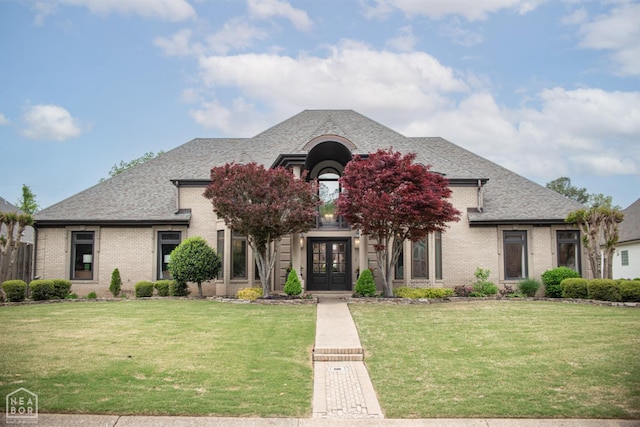 1203 Dove Rd, Jonesboro, AR 72401 - french country home with a front lawn, a shingled roof, french doors, and brick siding