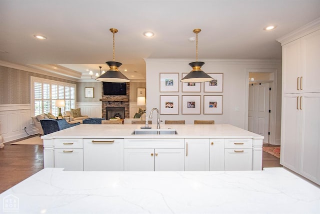 1203 Dove Rd, Jonesboro, AR 72401 - kitchen with open floor plan, a stone fireplace, crown molding, and a sink