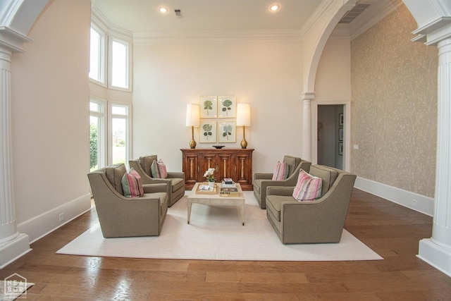 1203 Dove Rd, Jonesboro, AR 72401 - living room featuring ornate columns, arched walkways, and ornamental molding