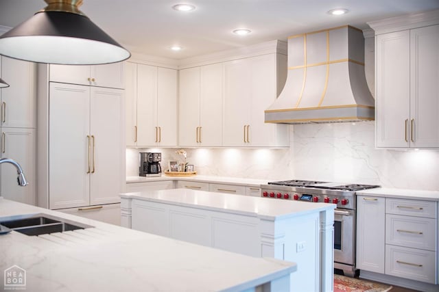 1203 Dove Rd, Jonesboro, AR 72401 - kitchen with a sink, a center island, high end stainless steel range, backsplash, and premium range hood