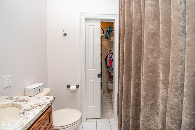 1203 Dove Rd, Jonesboro, AR 72401 - bathroom with vanity, toilet, tile patterned flooring, and a spacious closet