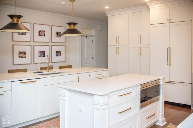 1203 Dove Rd, Jonesboro, AR 72401 - kitchen with dark wood finished floors, hanging light fixtures, ornamental molding, a sink, and white cabinetry