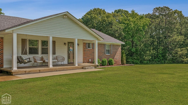 1766 Greene Road 326, Bono, AR 72416 - view of front facade featuring a porch, brick siding, roof with shingles, and a front yard