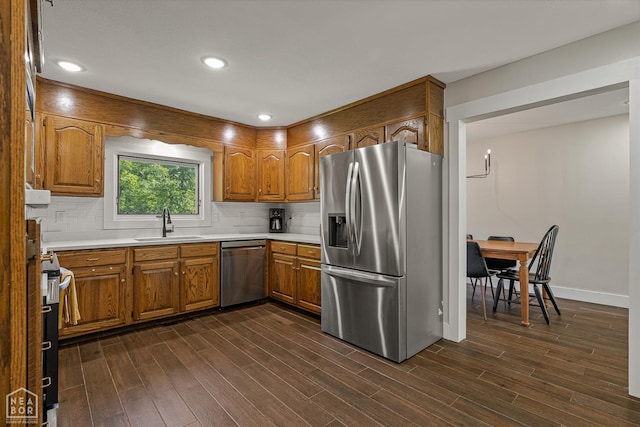 1766 Greene Road 326, Bono, AR 72416 - kitchen with stainless steel appliances, brown cabinetry, dark wood-type flooring, light countertops, and recessed lighting