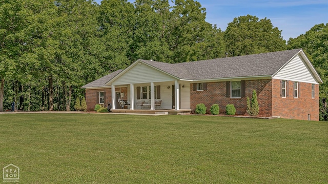 1766 Greene Road 326, Bono, AR 72416 - view of front of house with covered porch, brick siding, a front lawn, and a shingled roof