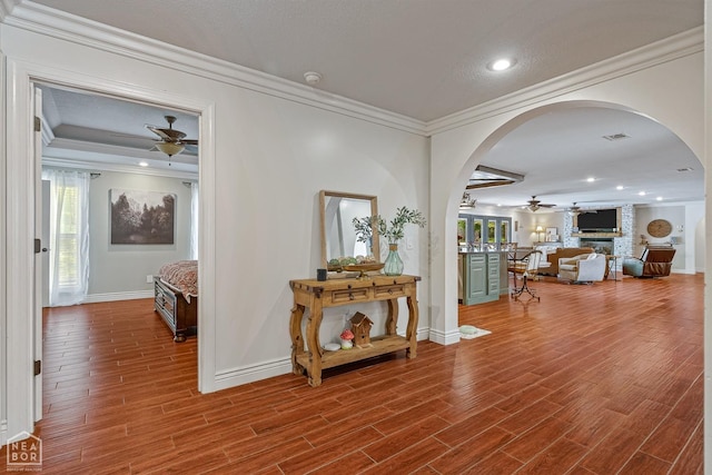1616 Neely Rd, Jonesboro, AR 72404 - hallway featuring arched walkways, wood finished floors, crown molding, and baseboards