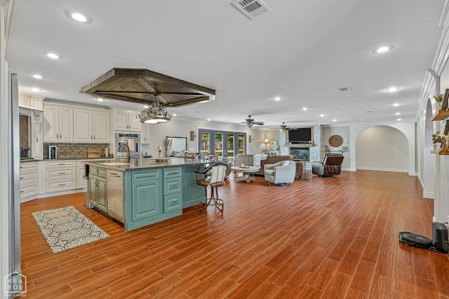 1616 Neely Rd, Jonesboro, AR 72404 - kitchen with dark countertops, open floor plan, oven, visible vents, and recessed lighting