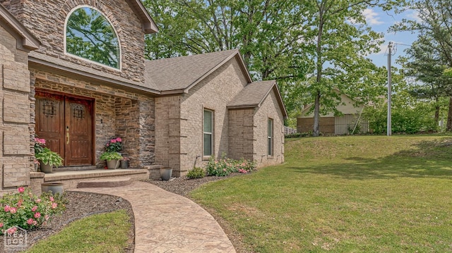 1616 Neely Rd, Jonesboro, AR 72404 - doorway to property with stone siding, a lawn, and a shingled roof