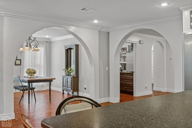 1616 Neely Rd, Jonesboro, AR 72404 - dining room featuring visible vents, baseboards, recessed lighting, wood finished floors, and crown molding