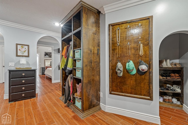 1616 Neely Rd, Jonesboro, AR 72404 - hallway featuring arched walkways, light wood-type flooring, crown molding, and baseboards