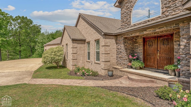 1616 Neely Rd, Jonesboro, AR 72404 - entrance to property with a yard, stone siding, and a shingled roof