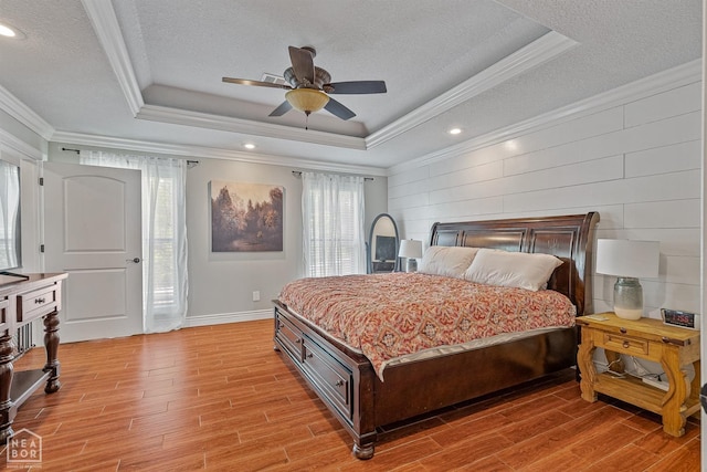 1616 Neely Rd, Jonesboro, AR 72404 - bedroom featuring access to exterior, a textured ceiling, light wood-type flooring, and a raised ceiling