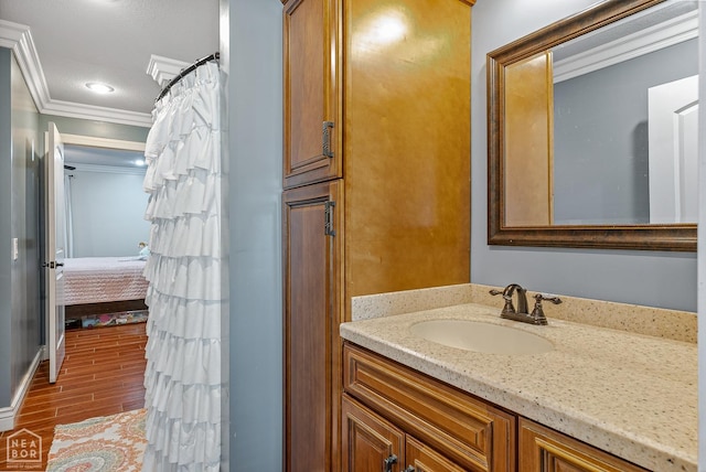 1616 Neely Rd, Jonesboro, AR 72404 - ensuite bathroom featuring crown molding, vanity, wood finished floors, and ensuite bathroom