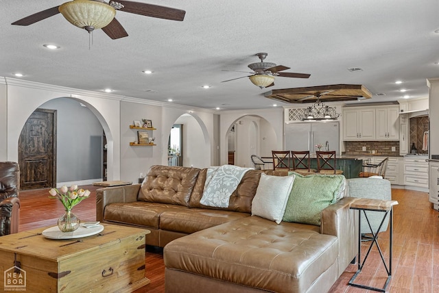 1616 Neely Rd, Jonesboro, AR 72404 - living area featuring light wood-type flooring, arched walkways, ceiling fan, and crown molding