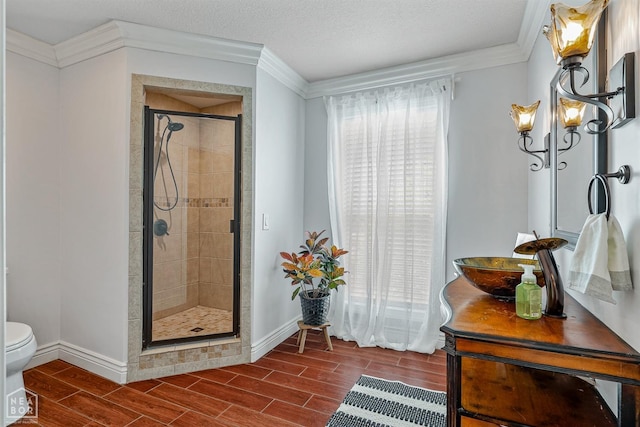 1616 Neely Rd, Jonesboro, AR 72404 - full bathroom featuring wood tiled floor, toilet, a stall shower, and ornamental molding