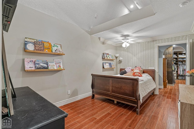 1616 Neely Rd, Jonesboro, AR 72404 - bedroom with arched walkways, wood finished floors, baseboards, and a textured ceiling