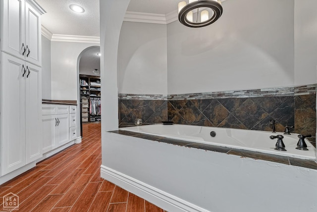 1616 Neely Rd, Jonesboro, AR 72404 - bathroom featuring a bath, wood finished floors, recessed lighting, and ornamental molding