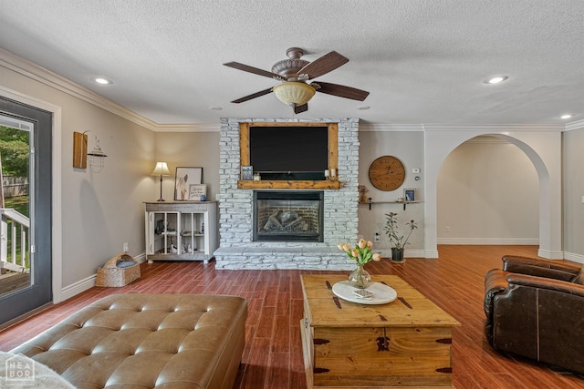 1616 Neely Rd, Jonesboro, AR 72404 - living room with a brick fireplace, wood finished floors, a textured ceiling, and baseboards