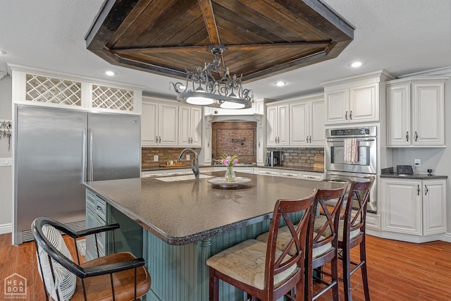 1616 Neely Rd, Jonesboro, AR 72404 - kitchen featuring light wood-style flooring, a sink, dark countertops, recessed lighting, and appliances with stainless steel finishes