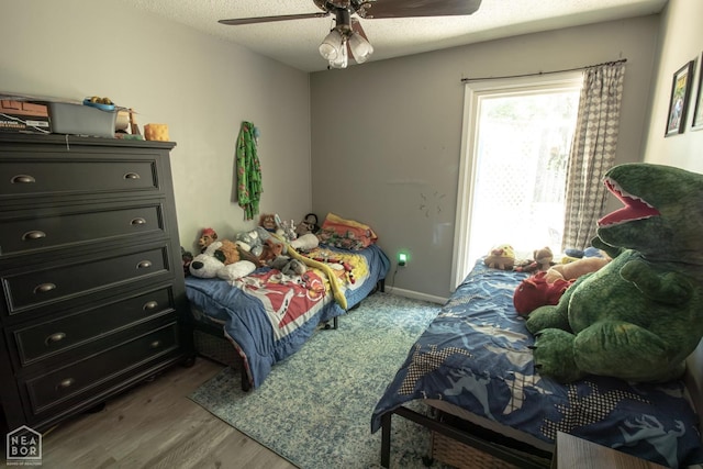 1705 Loberg Ln, Jonesboro, AR 72401 - bedroom with wood finished floors, ceiling fan, and a textured ceiling