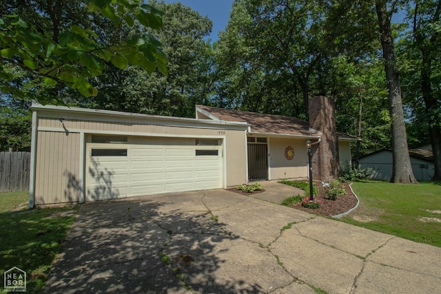1705 Loberg Ln, Jonesboro, AR 72401 - view of front facade with driveway, a garage, and a chimney