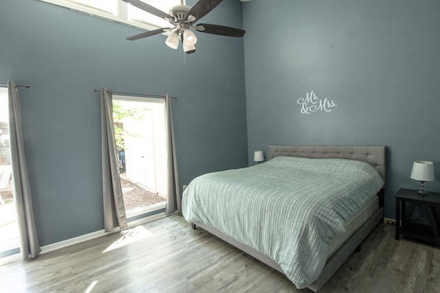 1705 Loberg Ln, Jonesboro, AR 72401 - bedroom with wood finished floors, baseboards, a ceiling fan, and a high ceiling