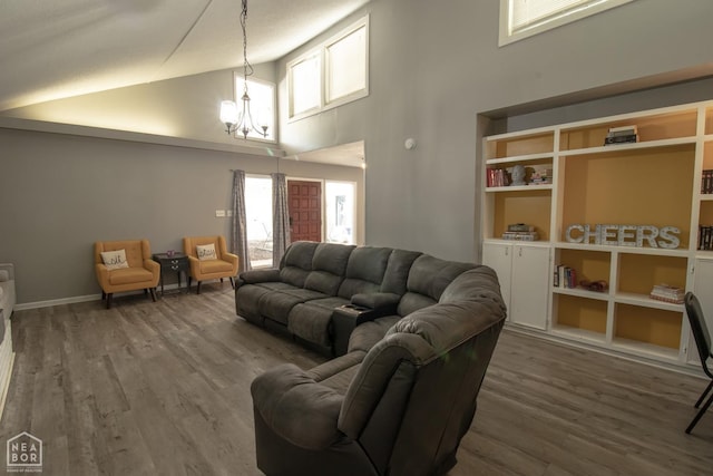 1705 Loberg Ln, Jonesboro, AR 72401 - living area featuring high vaulted ceiling, a chandelier, and wood finished floors