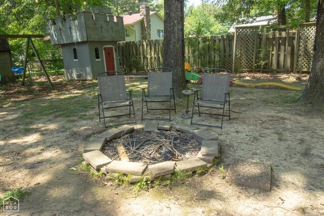 1705 Loberg Ln, Jonesboro, AR 72401 - fenced backyard featuring a fire pit