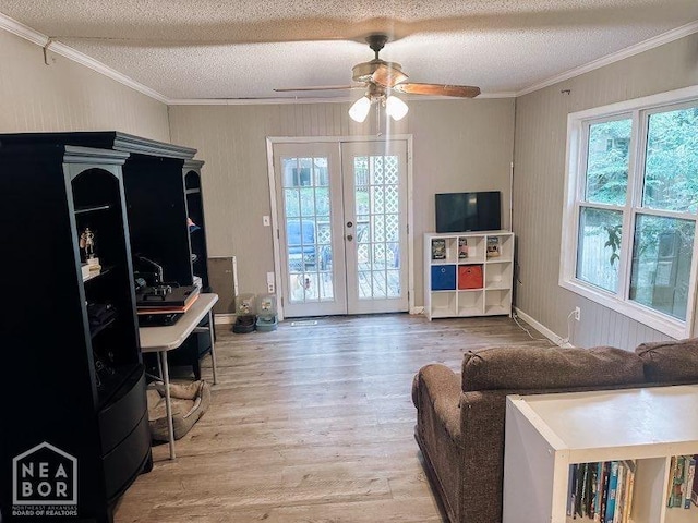 1705 Loberg Ln, Jonesboro, AR 72401 - living area with ornamental molding, french doors, a textured ceiling, light wood-type flooring, and ceiling fan