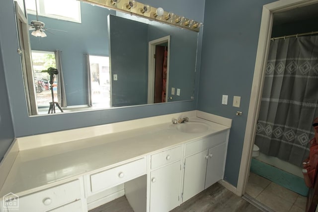1705 Loberg Ln, Jonesboro, AR 72401 - bathroom with vanity, toilet, a ceiling fan, and a shower with curtain