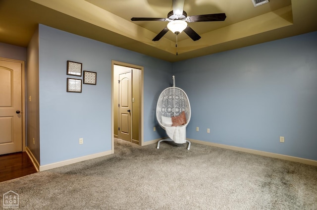 103 Hollis Cv, Bono, AR 72416 - unfurnished bedroom featuring carpet, a tray ceiling, baseboards, and a ceiling fan
